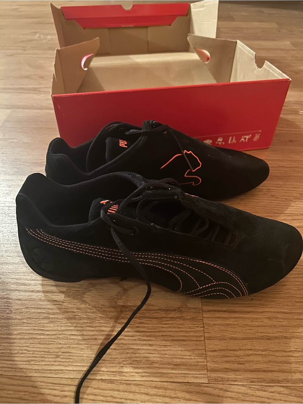 Puma Women’s Black Sneakers with Orange Accents